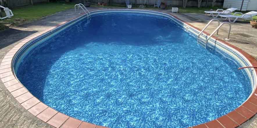 The same pool after Suns Out Buns Out green-to-clean service: sparkling blue water