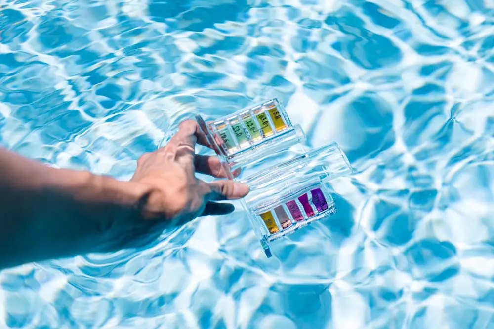 Professional pool water testing kit floating in crystal-clear water